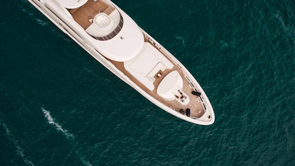 white-and-black-boat-on-blue-sea-during-daytime-nzpztkwl5vi